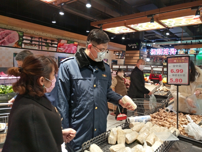 圖為李兵（左二）在超市檢查。