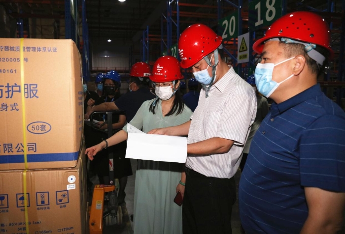 圖為檢查組在企業(yè)醫(yī)用防護服生產(chǎn)車間檢查