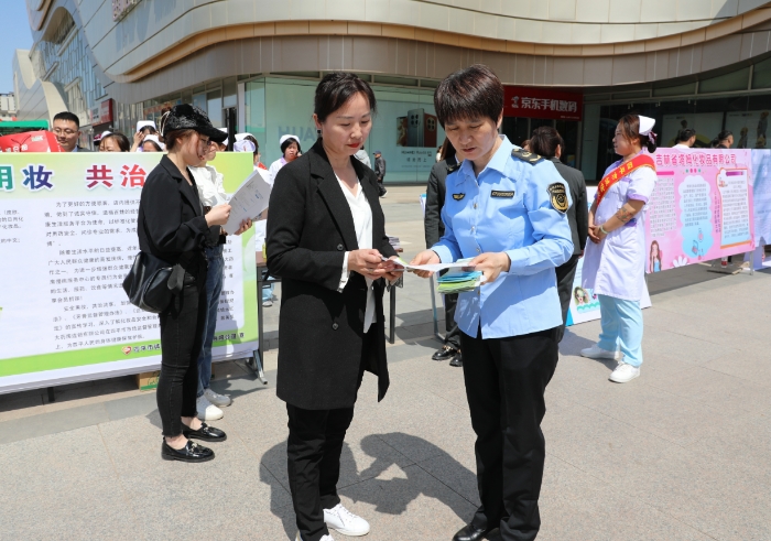 圖為監(jiān)管人員為群眾講解化妝品安全科普知識(shí)。（葉陽歡 攝）