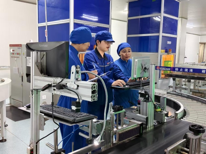 圖為第三分局執(zhí)法人員在一家藥品生產(chǎn)企業(yè)車間現(xiàn)場對藥品包裝賦碼情況進行檢查。（盧昶君 攝）